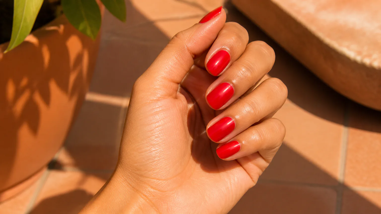 Hand with bright red painted nails