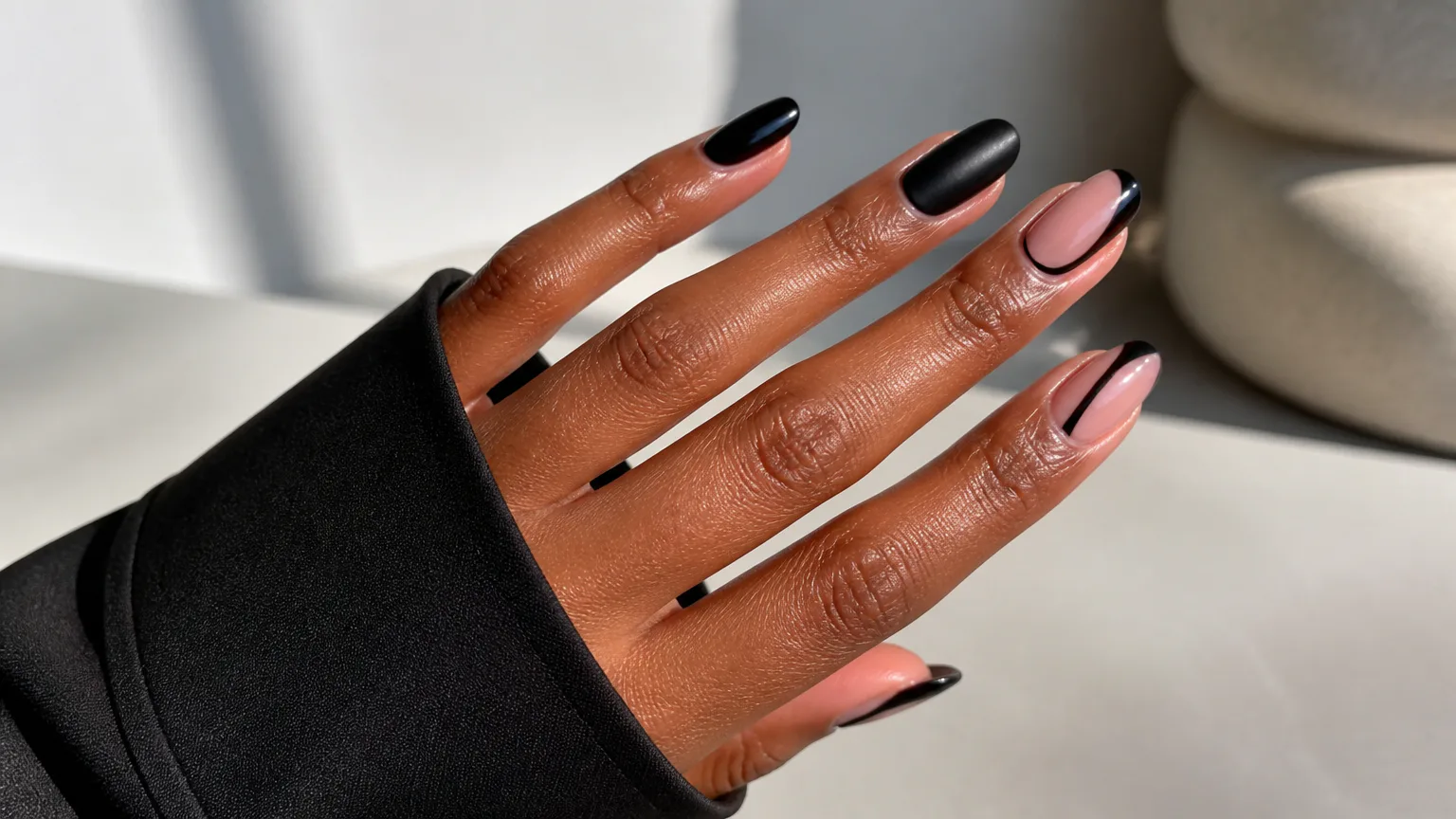 polish still Hand with black and pink manicured nails
