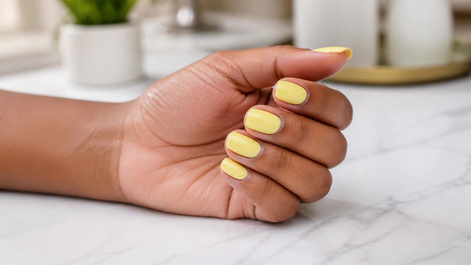 OPI Sunny Bunny Hand with glossy yellow nail polish